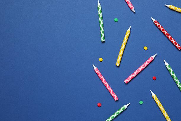 istock Multi-colored holiday candles on a color background, flat lay. Birthday concept 2251773296