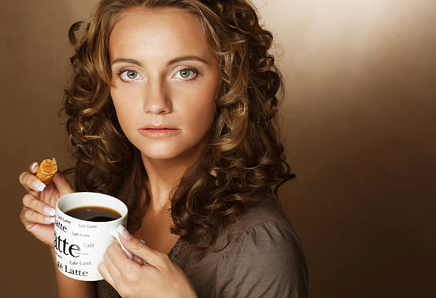 istock Young woman with an aromatic coffee in hands 2251776012