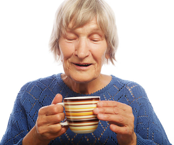 istock Happy old lady with coffee 2251776358