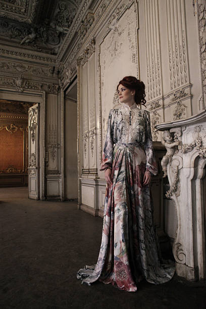 istock woman  posing next to the fireplace 2251776599