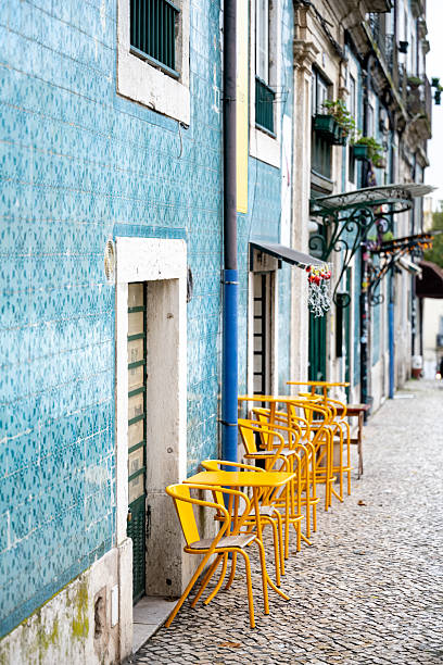 istock Yellow chairs outside cafe on tiled street 2251780312