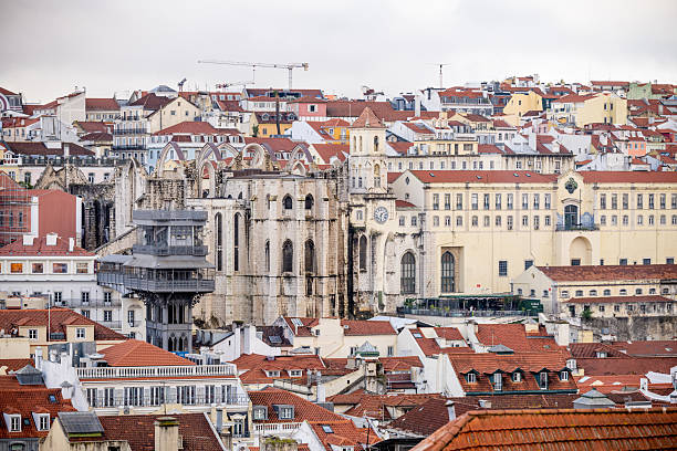 Lisbon Portugal December 05 2025. Rooftops and hillside houses with a historic monastery in the Alfama district under cloudy winter light.