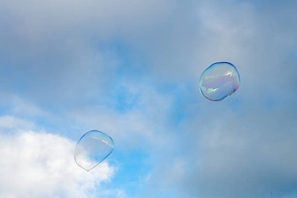 Background material of refreshing blue sky, clouds and sparkling soap bubbles