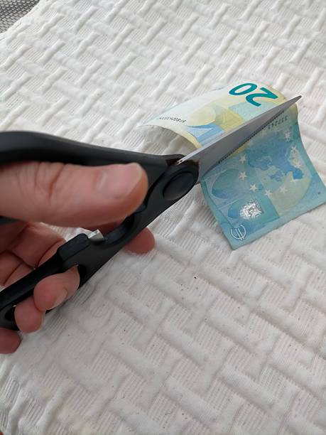 istock cutting a twenty euro bank note with a pair of scissors 2251782338
