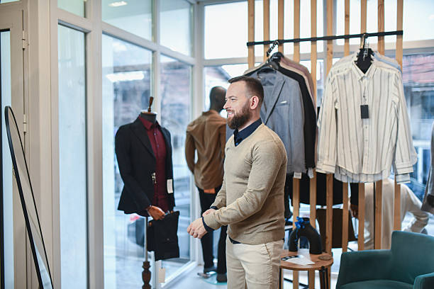 istock Satisfied Man In Store Trying On Clothes, Smiling While Shopping And Looking At Mirror 2251782798