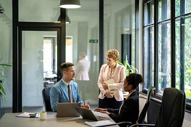 istock Business professionals engaging in office discussion 2251785341