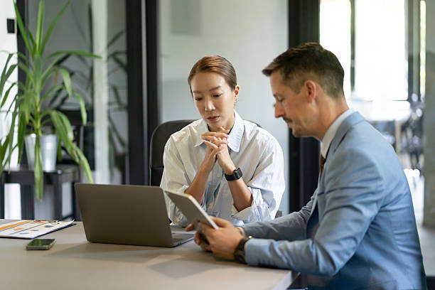 istock Business colleagues collaborating on a project using digital tablet and laptop in office 2251785363