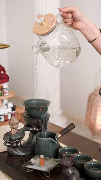 istock Liquid pour tea time woman hand glass incense 2251786343