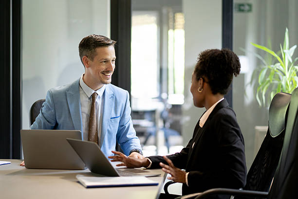 istock Business partners discussing a project using laptops in the office 2251786454