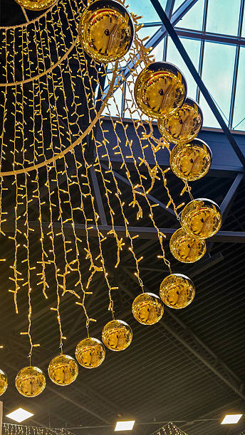 istock A festive Christmas decorations, hanging from a ceiling adorned with sparkling lights and ornaments 2251788688