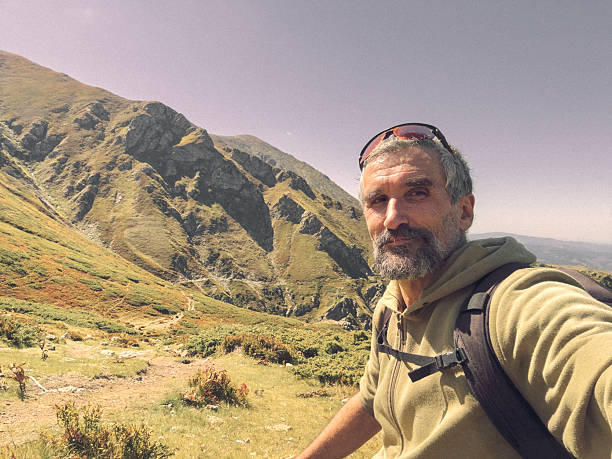 istock Mature Hiker Taking Selfie Enjoying Mountain Landscape View 2251789012