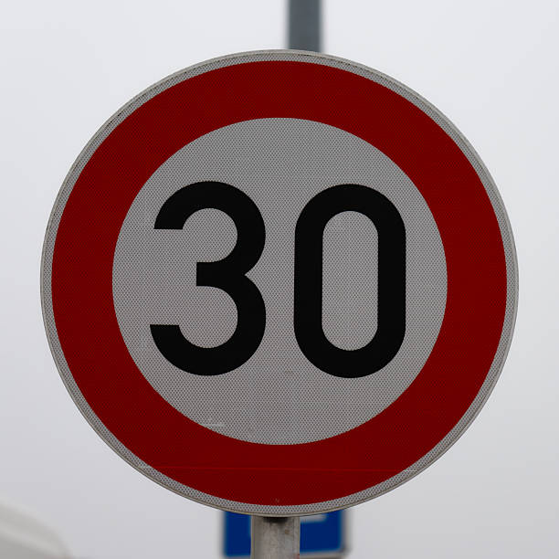 istock Circular 30 speed limit traffic sign on pole 2251789684
