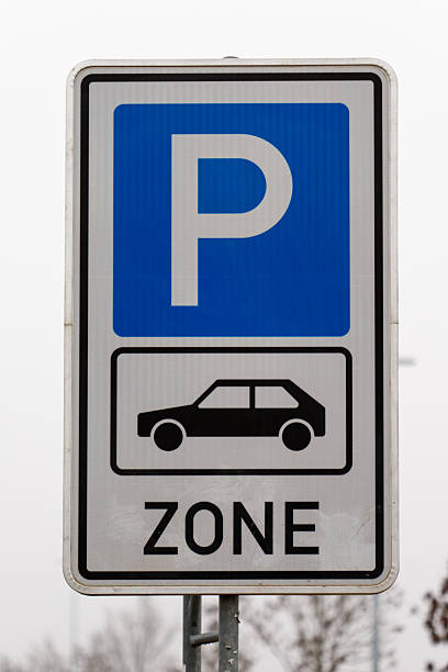 istock Parking zone sign showing car symbol on gray sky 2251789687