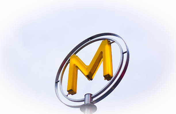 Paris, France - October 28, 2025: A vintage yellow metro sign \
