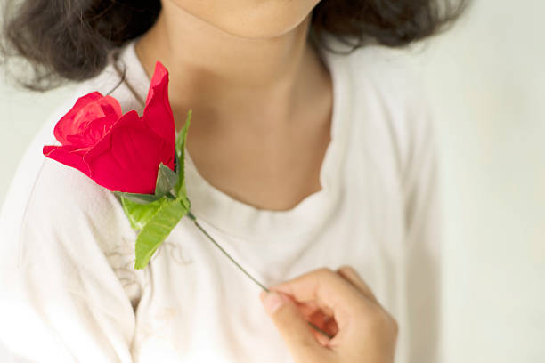 istock Red Fabric Rose Held Near Chest 2251796142