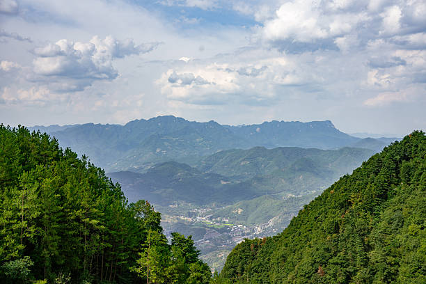 istock Scenic mountain landscape with lush green trees under a cloudy sky 2251797096