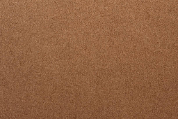 istock Craft Paper Surface with Grainy Texture and Earth Color Macro View 2251798584