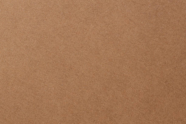 istock Craft Paper Surface with Grainy Texture and Earth Color Macro View 2251798595
