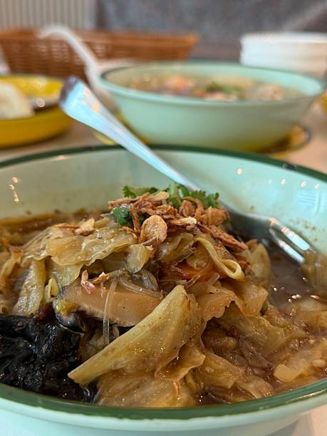 Close-up of a bowl of Peranakan Nyonya Chap Chye aka Braised Mixed Vegetable Stew. Peranakan or Nyonya style chap chye refers to a mixture of vegetables along with other flavorful ingredients cooked in one pot or wok. Comes with vegetarian and non-vegetarian versions