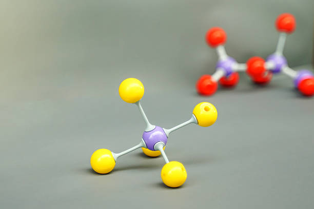 A colorful ball-and-stick model representing a covalent molecule (e.g., Tetrahedral or Carbon compound) displayed in a chemistry lab or classroom setting. Focuses on science education.