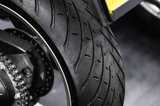istock A motorcycle rear wheel, chain, sprocket, and tire, close up view 2251817382