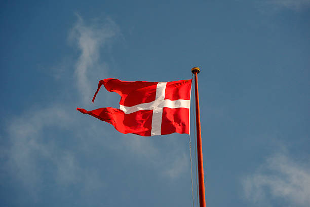 A danish denmark flag waving in blue sky background