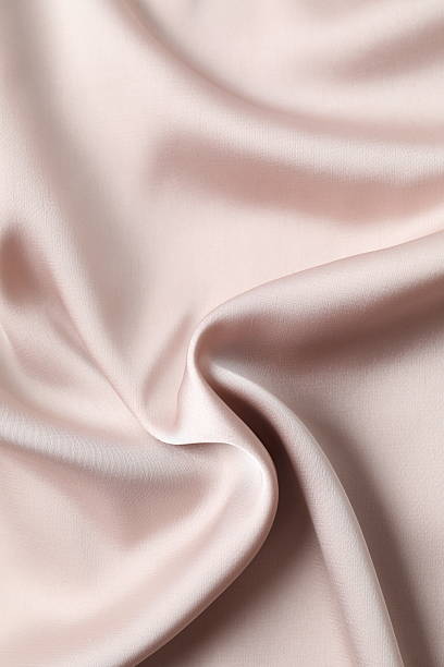 istock Beige silk satin. Shiny smooth fabric. Soft folds. Luxury background with space for design. Flat table, top view 2251818123