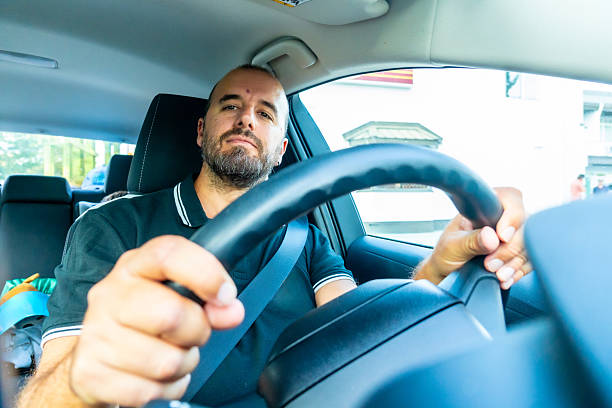 istock Man driving car in urban setting in british columbia 2251819213