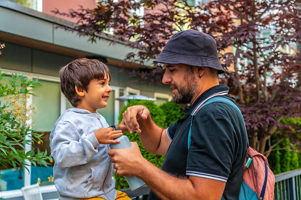 istock Father helping son opening a water bottle in vancouver 2251819246