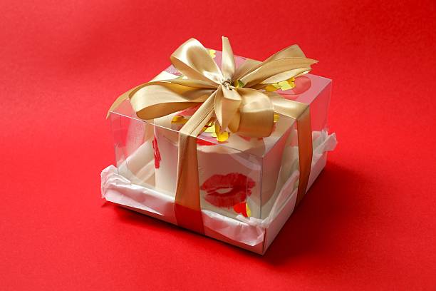 Valentines Day Chocolate Truffles Gift and Lighting Decorations on Silk Red Background