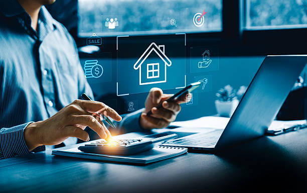 istock Business professional analyzing digital real estate data using smartphone, laptop, and calculator to evaluate home loan options, property value, strategic investment insights in a fintech environment 2251819709