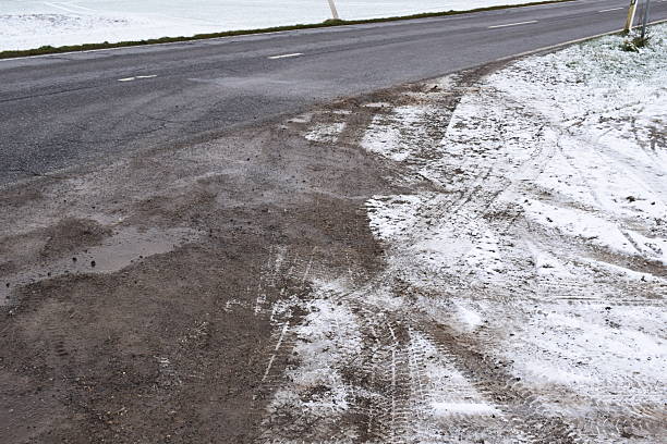 istock tire tracks in dirt and snow 2251819736