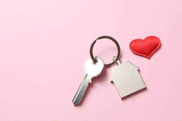 istock Beautiful red heart and key on pink background 2251819947