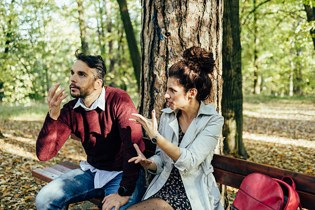 istock Couple arguing outdoors on park bench expressing disagreement 2251820205