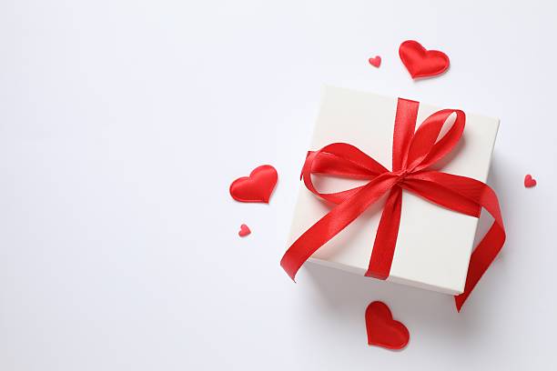 istock Gift box with red hearts on white background 2251820233