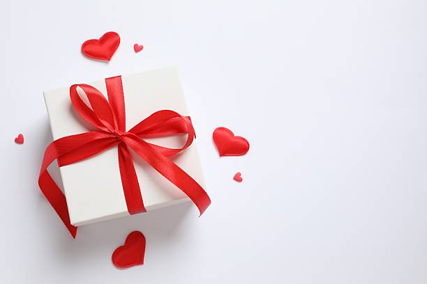 istock Gift box with red hearts on white background 2251820239