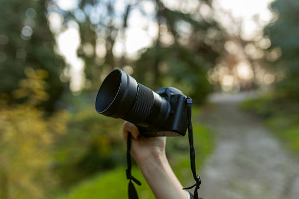 istock Close-up of a digital camera held up by a hand 2251820568