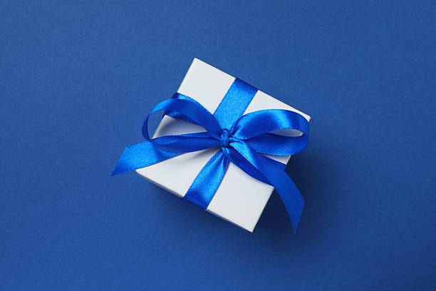 istock Festive gift box on color background 2251821295