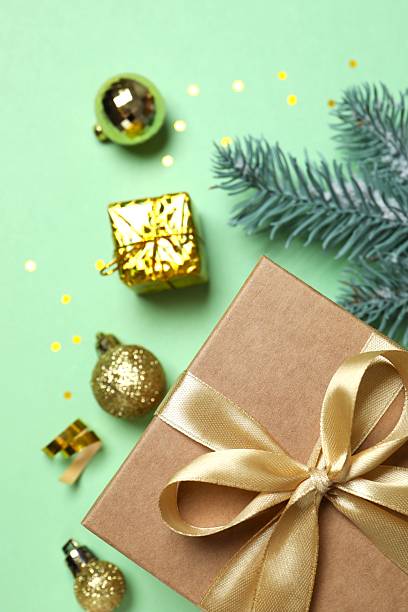istock Christmas gift box and decorations on color background,  seasonal greeting 2251821421