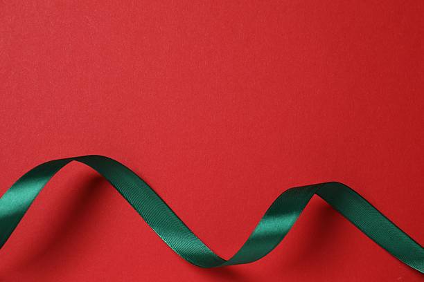 istock Beautiful green silk ribbon on color background, space for text 2251821559