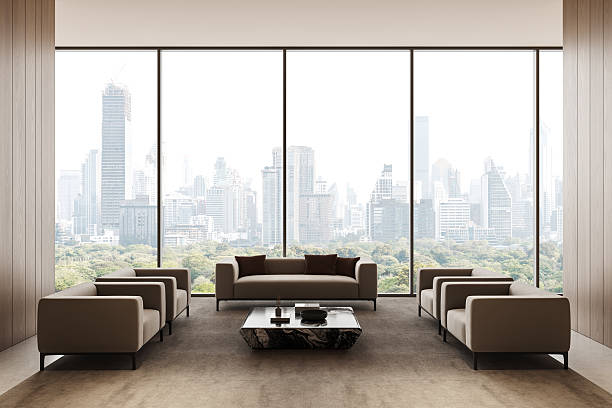istock Modern luxury interior design with beige armchairs and panoramic city view through large windows in a high-rise lounge space. 3D Rendering 2251821742