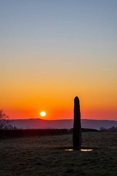 istock Ancient standing stone at sunrise in Bourgogne Franche Comte 2251822760