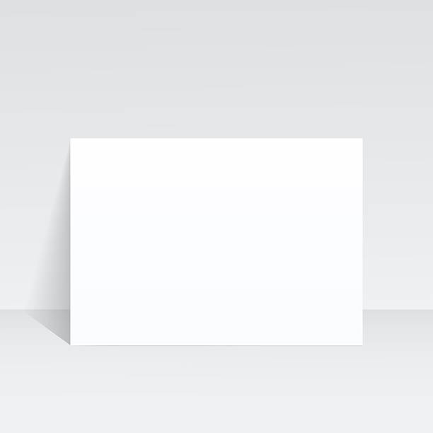 istock An A4 sheet of paper stands against the wall on a gray background. 2251823672