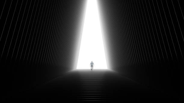 istock Man walking up a long, dark staircase toward a brightly lit exit, symbolizing new opportunity, success journey, and future hope, 3d render 2251829281