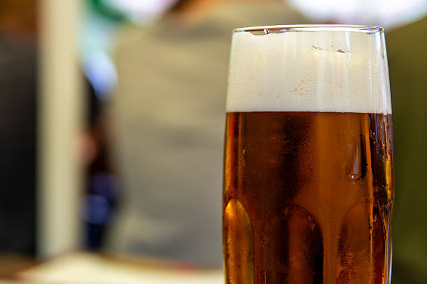 istock Pint Of Cold Amber Beer With Foamy Head On Bar Table Refreshing Drink For Pub. Copy Space 2251830507