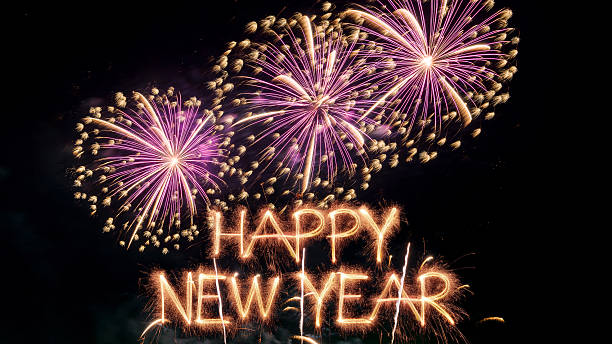 Sparkler Happy New Year text colorful firework illumination on dark blue sky background, happy new year 2026 concept