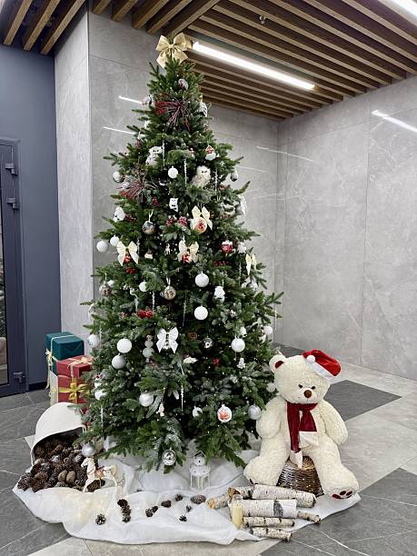 istock Festive Hotel Lobby Features Sparkling Ornaments And Warm Lighting Effects, Charming Holiday Arrangement In Hotel Lobby With Plush Teddy And Glowing Decorations Enhances Festive Spirit 2251831348