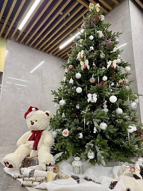 istock Festive Hotel Lobby Features Sparkling Ornaments And Warm Lighting Effects, Charming Holiday Arrangement In Hotel Lobby With Plush Teddy And Glowing Decorations Enhances Festive Spirit 2251831407