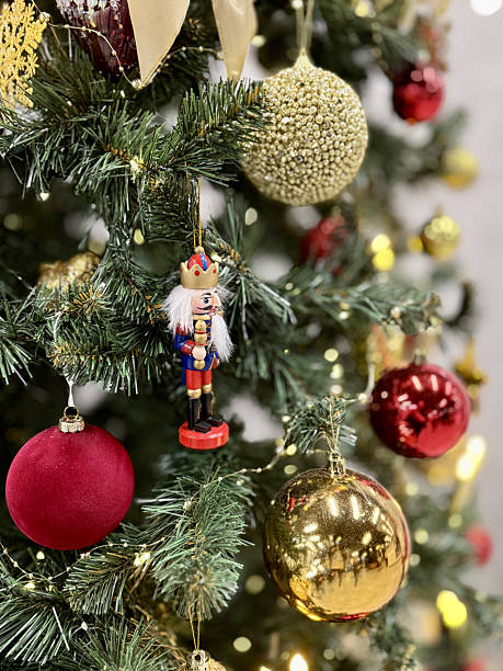 istock Festive Christmas Tree Ornaments Glowing Candles, Red And Gold Baubles, Glass Star, Nutcracker Figurine, Delicate Tinsel And Garland, Warm Bokeh Lights And Candlelight, Lush Pine Branches 2251831521