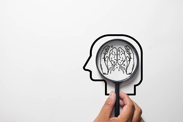 istock Hand with Magnifying Glass analyzing Human Brain, Mental Health, and Artificial Intelligence Concept. 2251833103